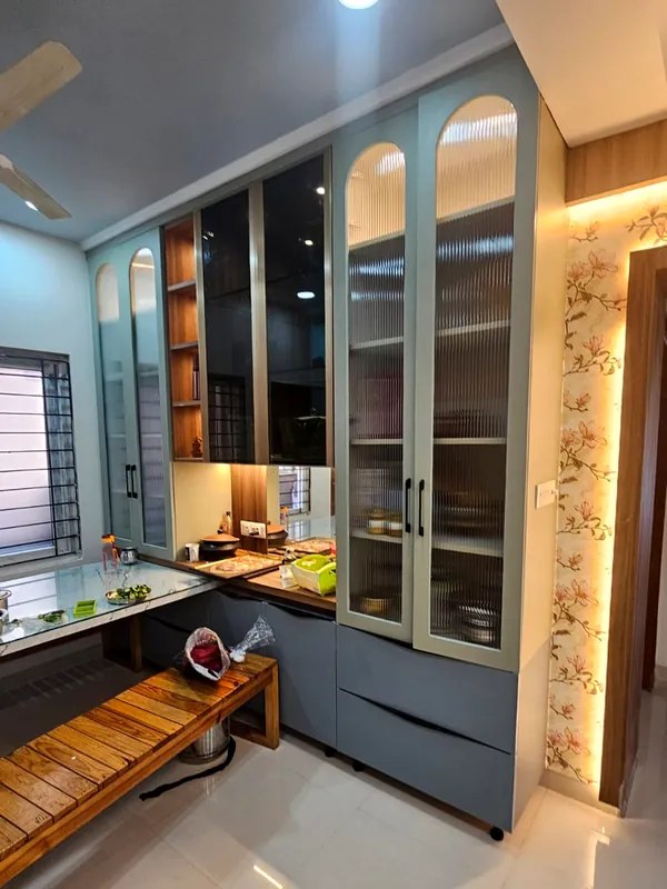 Arched glass cabinets beside floral wallpaper.