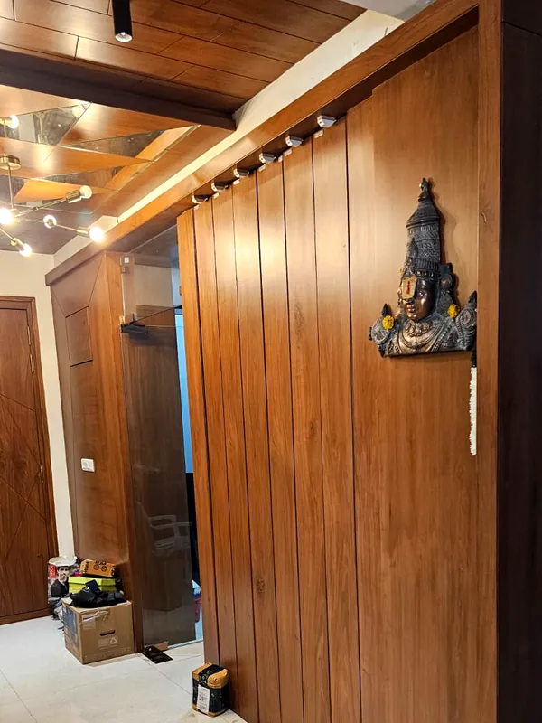 Vertical timber panels and brass wall art.